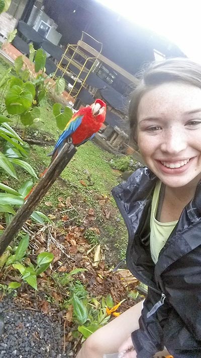 Hannah Landau Poses with a Parrot in Ecuador
