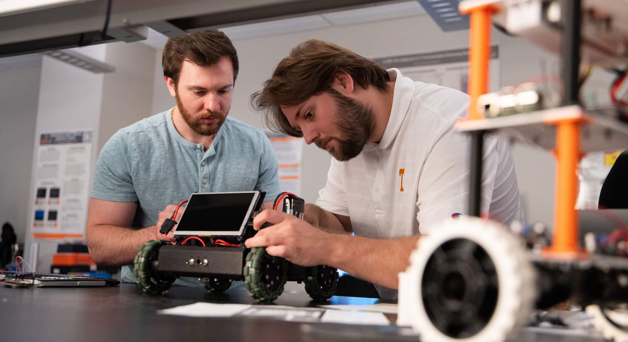 Graduate students Adam Foshie and Charles Rizzo work on autonomous vehicle GRANT
