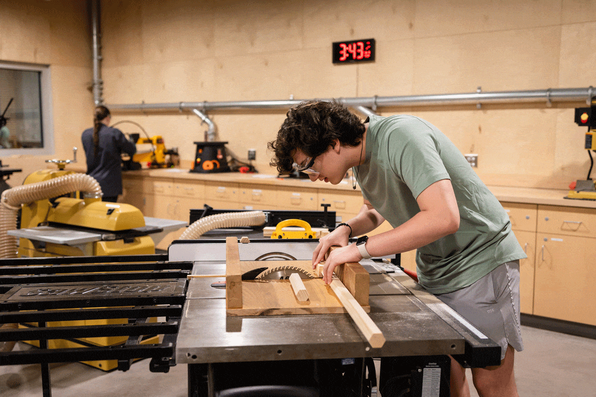 Student working in wood shop in the ICS