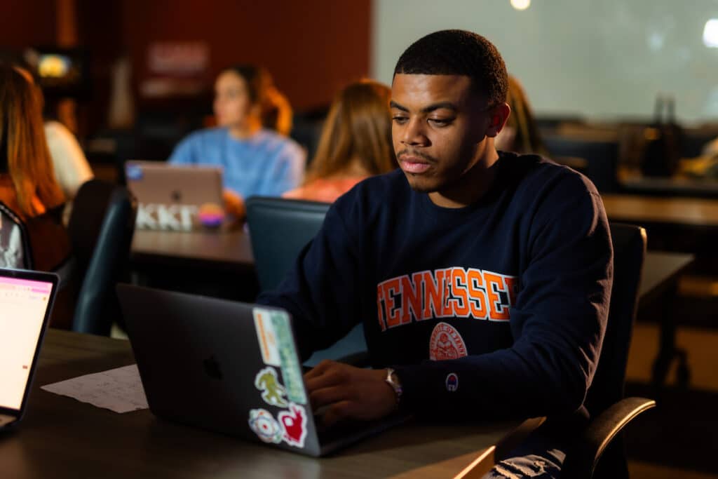 Undergrad students work on community engagement research in the Grid Control and Visualization Lab for the Center for Ultra-Wide-Area Resilient Electronic Energy Transmission Networks (CURENT) inside the Min H. Kao Electrical Engineering and Computer Science Building