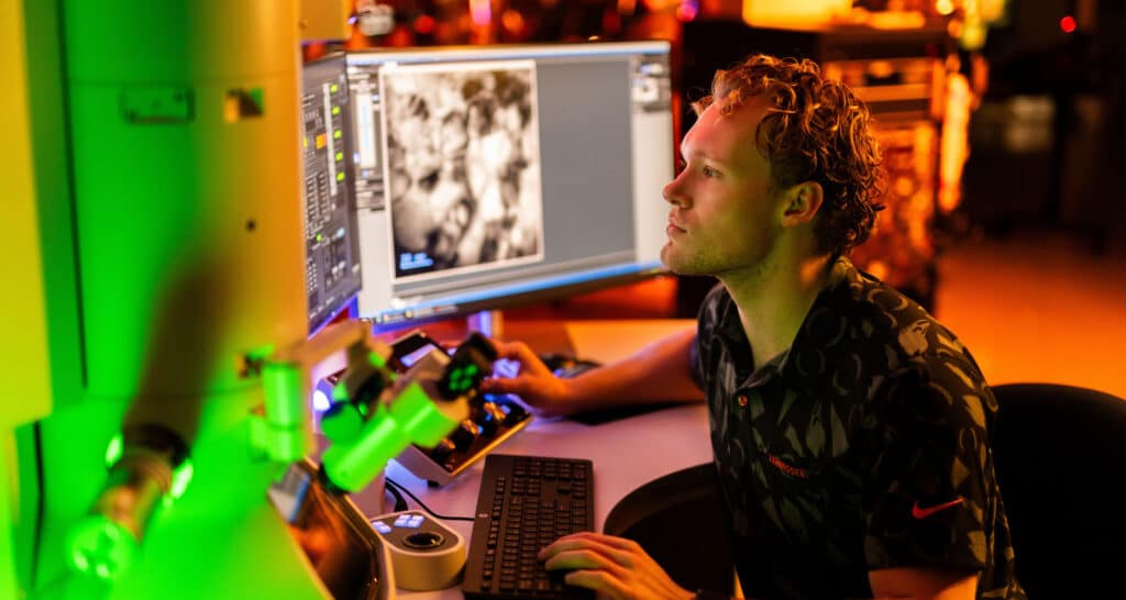 Andrew Wood, 1st year phd student, Civil Engineering and Structural Engineering, uses a transmission scanning microscope in the Ion Beam Materials Laboratory