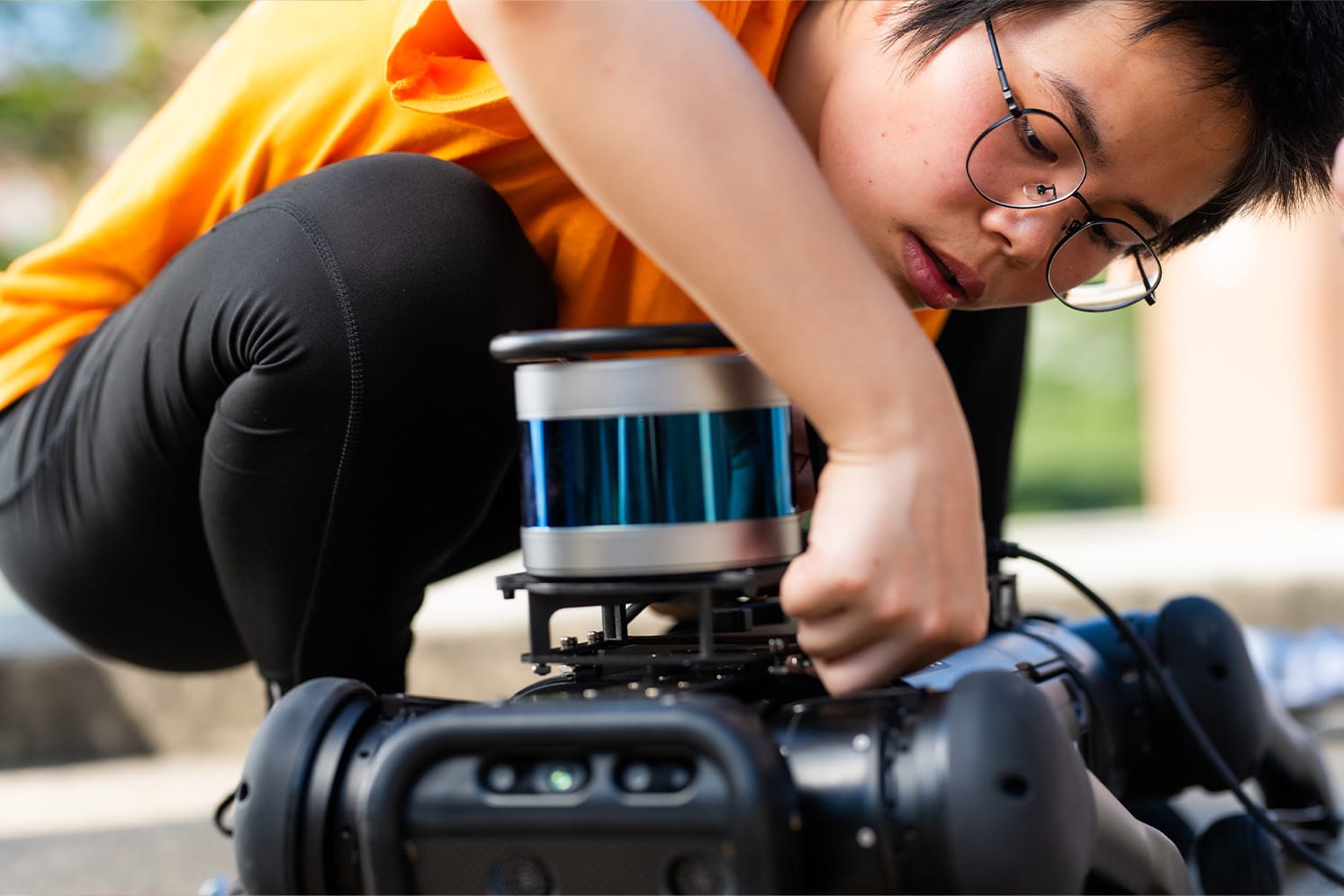 Student works with robotic dog.