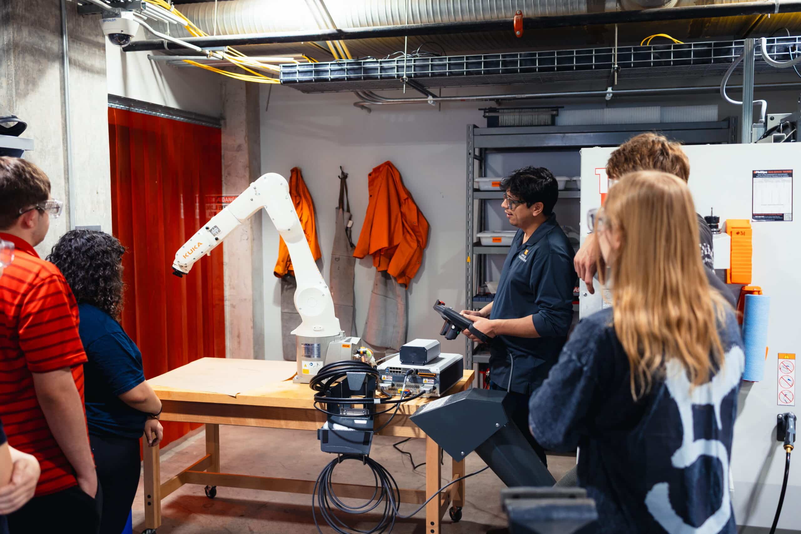 Applied Engineering Assistant Professor of practice Jose Nazario Moreno demonstrating a mechanical arm
