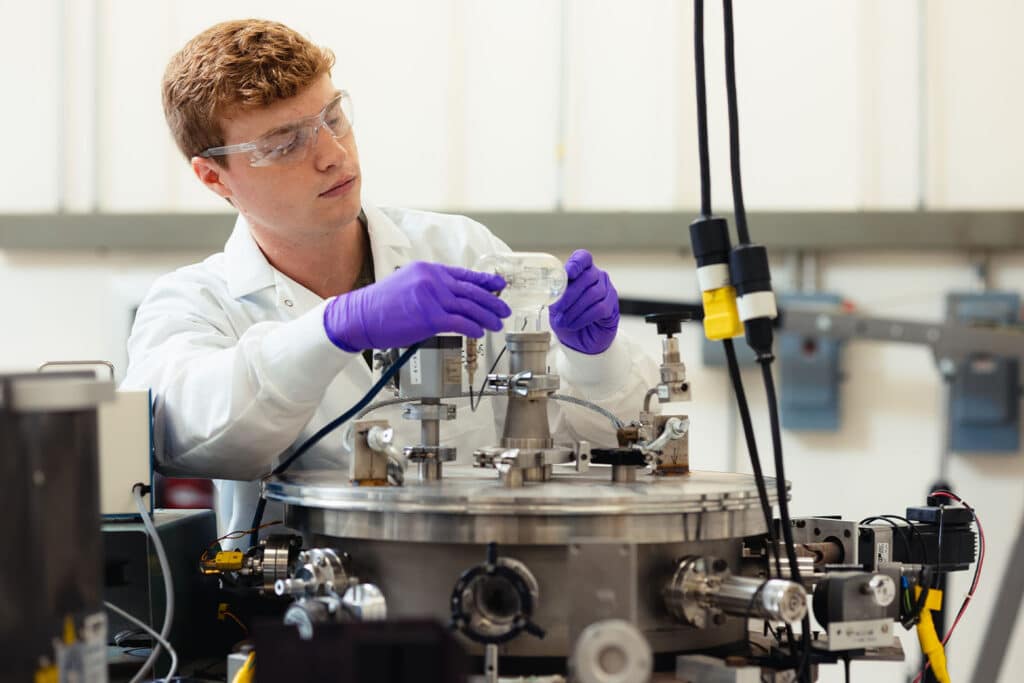 Student works with research equipment inside the BEAMS Lab