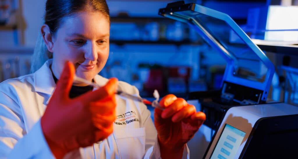 Alumna Natalie Gosnell (BS biomedical engineering ’19, MBA ’23) works in an Orion Therapeutics pharmaceuticals lab in the Institute for Advanced Materials and Manufacturing