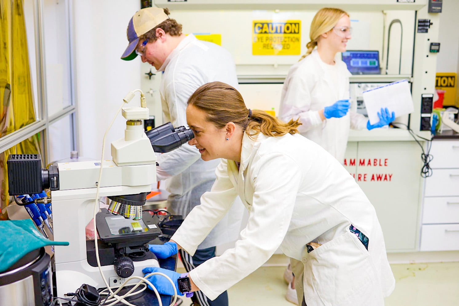 Colleen Crouch works with two students in her lab