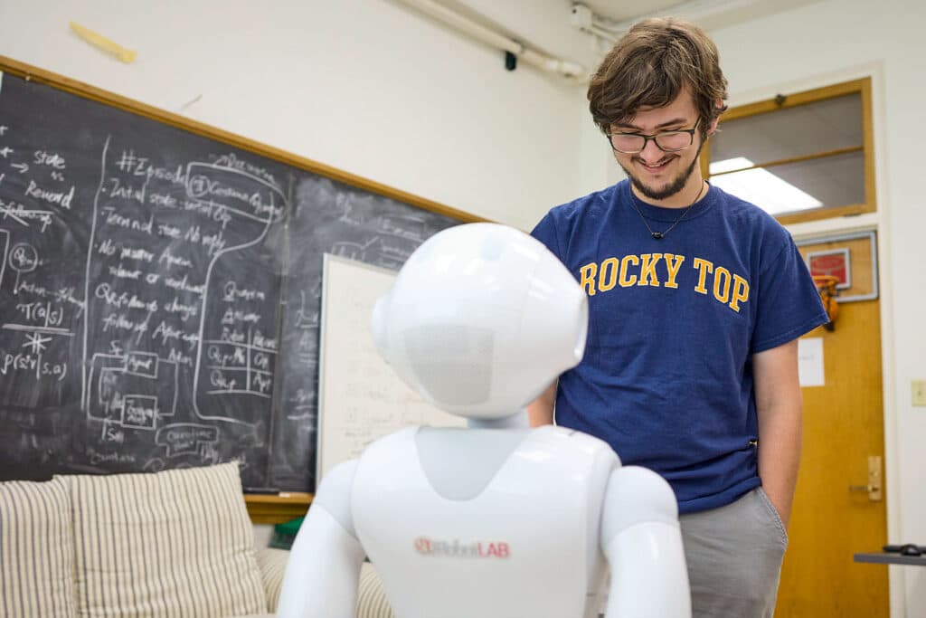 Student works with robot int he robot assistance lab