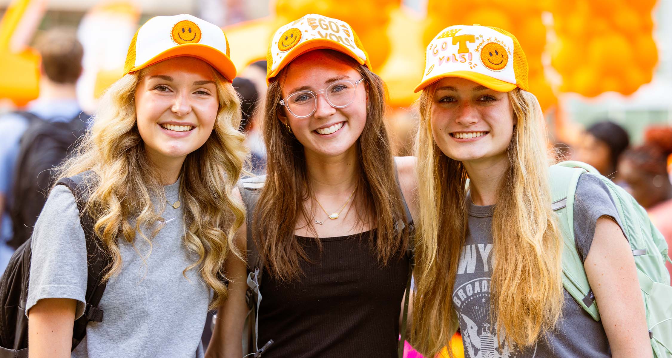 Three students at a Welcome Back event. 