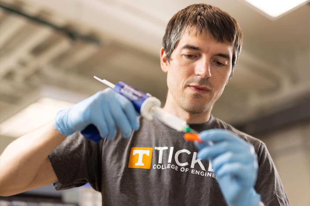 Dustin Crouch works with prosthetic limb in his lab.