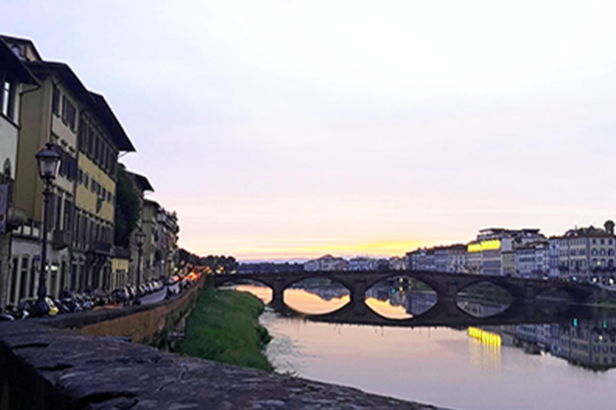 A sunset over a canal in Florence, Italy.