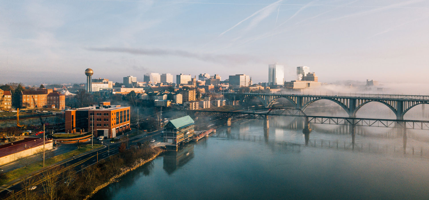 Aerial drone photo of the John D. Tickle Engineering Building, Tennessee River, Henley Street Bridge and Downtown Knoxville during a foggy morning