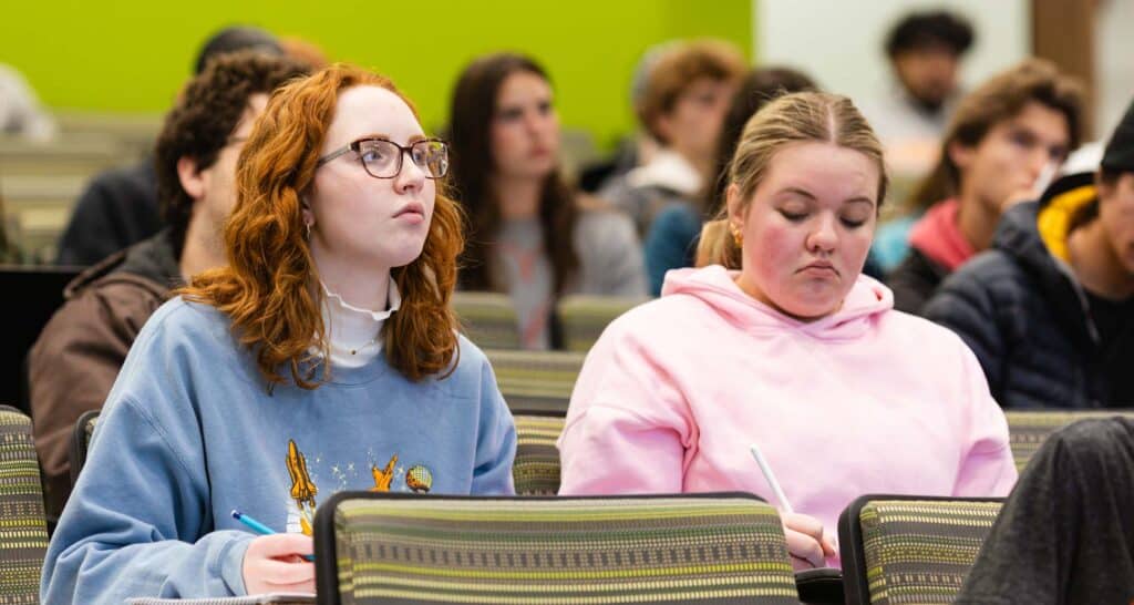 Two students sit in an undergrad class in Dougherty Hall