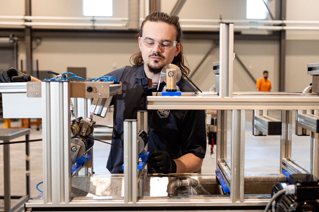 Student works with carbon fiber line in the FCMF