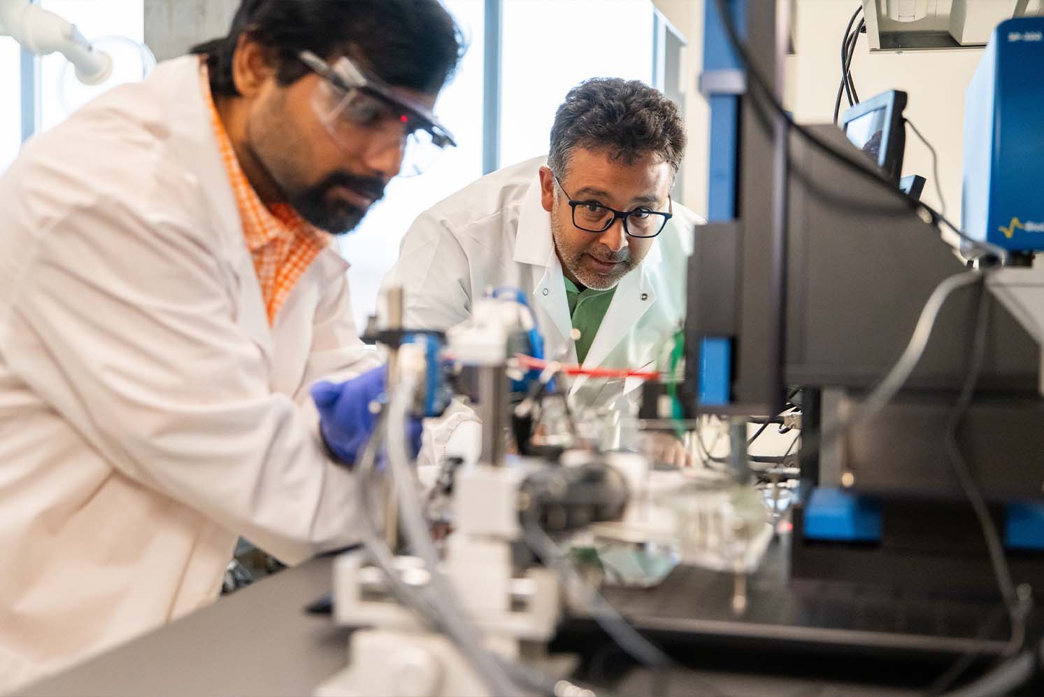 Senior Research Associate Gabriel A. Goenaga-Jiménez works with graduate student Anirban Roy at the scanning electrochemical workstation in a lab in Zeanah Engineering Complex.