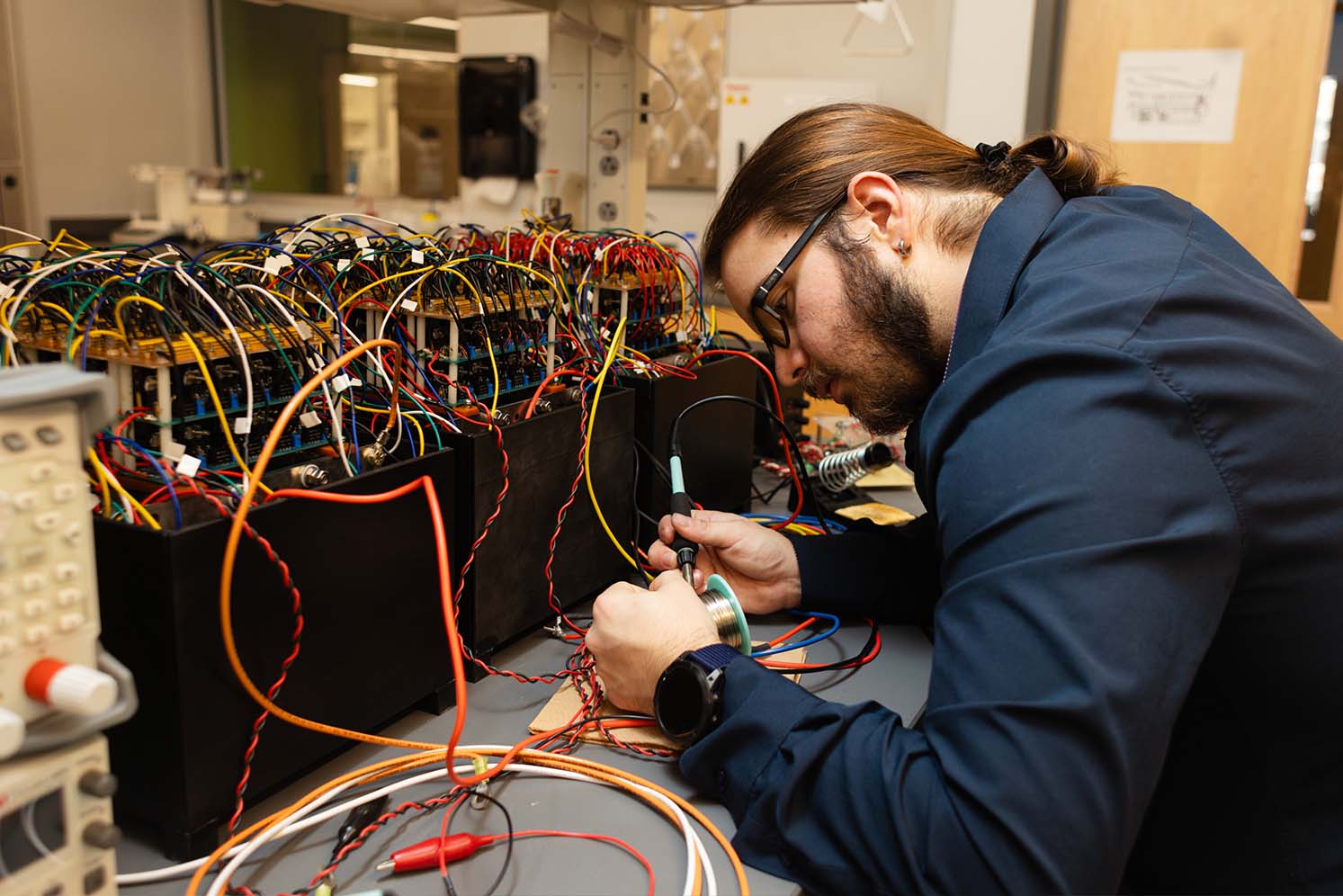 Graduate student works on project in Arc battery lab