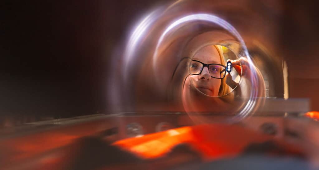 Student looks inside experiment during Engineers Day