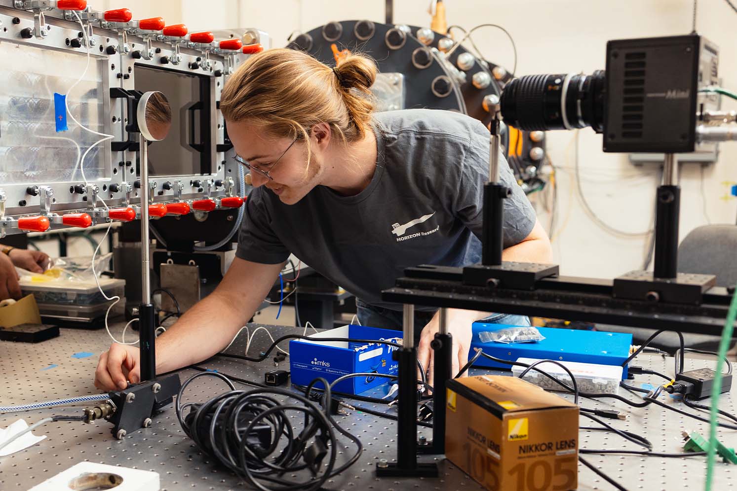 UTSI graduate students sets up instruments to use with wind tunnel.