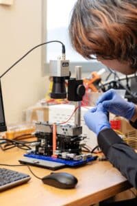 Shaodong Zhang working on a machine