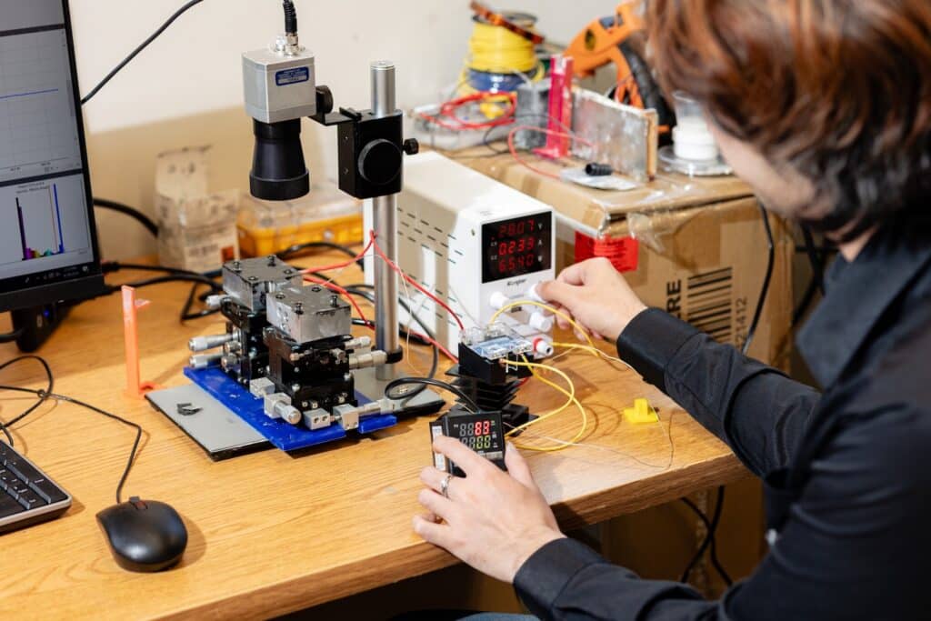 Shaodong Zhang setting up a machine