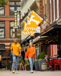 Two students walking in Market Square in downtown Knoxville.