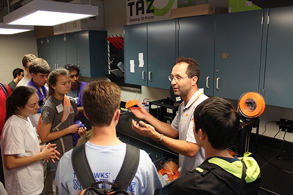 Students listen intently to a professor providing instruction.
