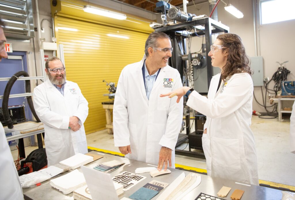UTK MSE PhD student Cece Grubb explains her dissertation work on bio-based paneling for automobiles to help Volkswagen meet their goals of a 100% recyclable vehicle to Pablo Di Si, President and CEO of Volkswagen Group of America. Cece’s advisor, Prof. David Harper of the Center for Renewable Carbon looks on.