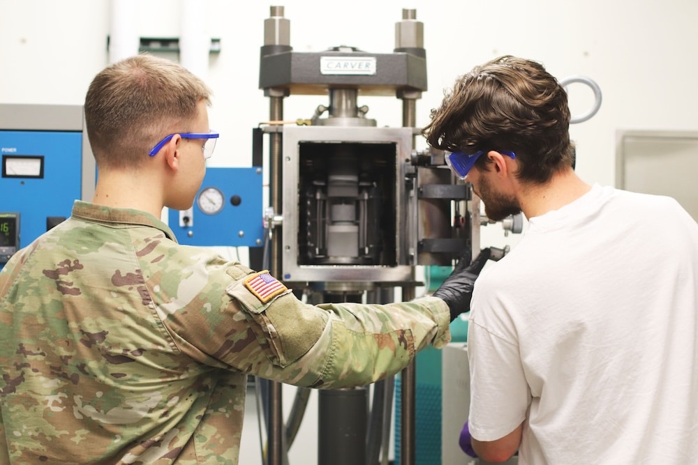 James Ross and Sean Drewry working on equipment in a lab