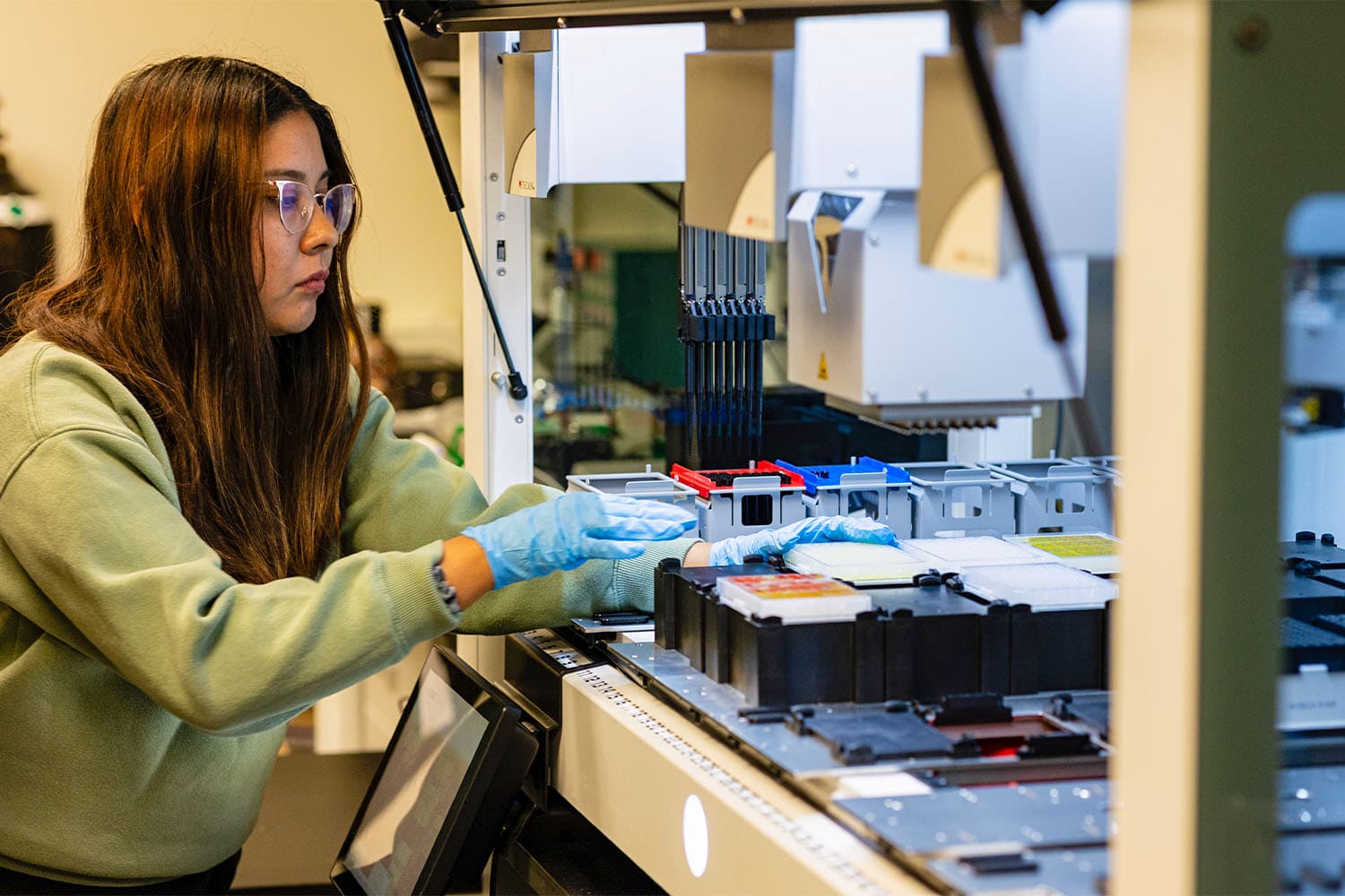 Student works with sample inside material synthesis lab