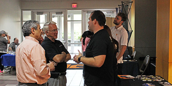 Associate Dean Masood Parang and Dean Wayne Davis chatted with representatives from Garmin during the cookout.