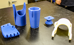 Some of the 3D printed parts that make up a synthetic arm.