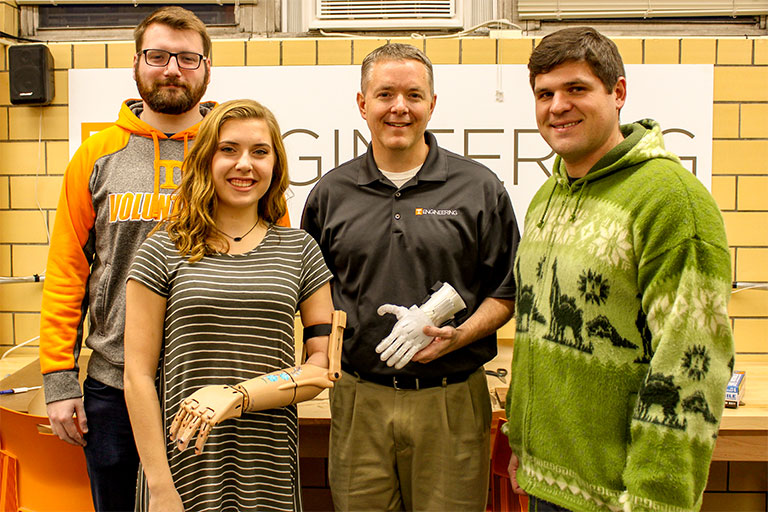Makers club president Chase Cumbelich, from left, freshman Riley Toll, associate professor of mechanical, aerospace and biomedical engineering Chad Duty and senior Alex Weber show some of the 3D printed limbs that the club has made.