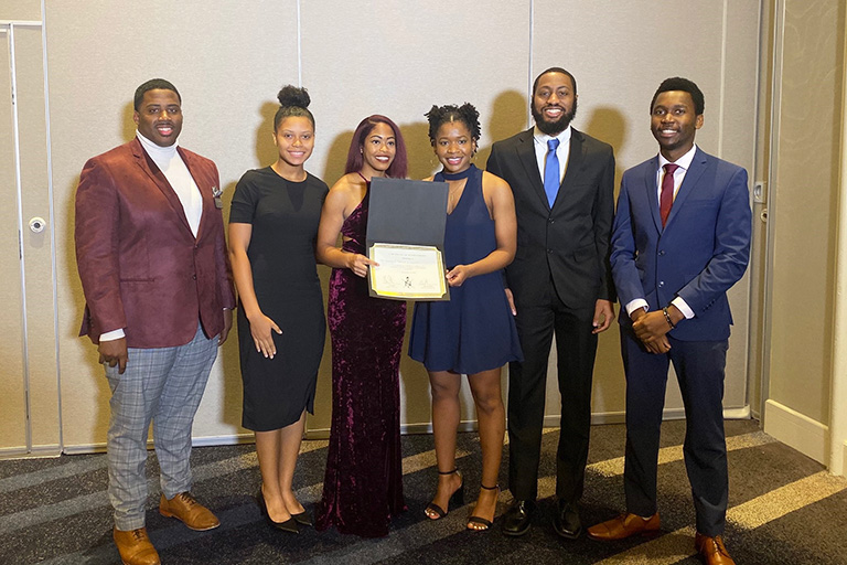 Anthony Fisher, NSBE Region 3 Chair, presents UT NSBE members with their first-place win in the 2019 Region 3 Academic Technology Bowl. With him from left are Kassidy Boone, Sydnee Ruff, Shannon Sharp, Hunter Mann, and Mubuso Nkosi.