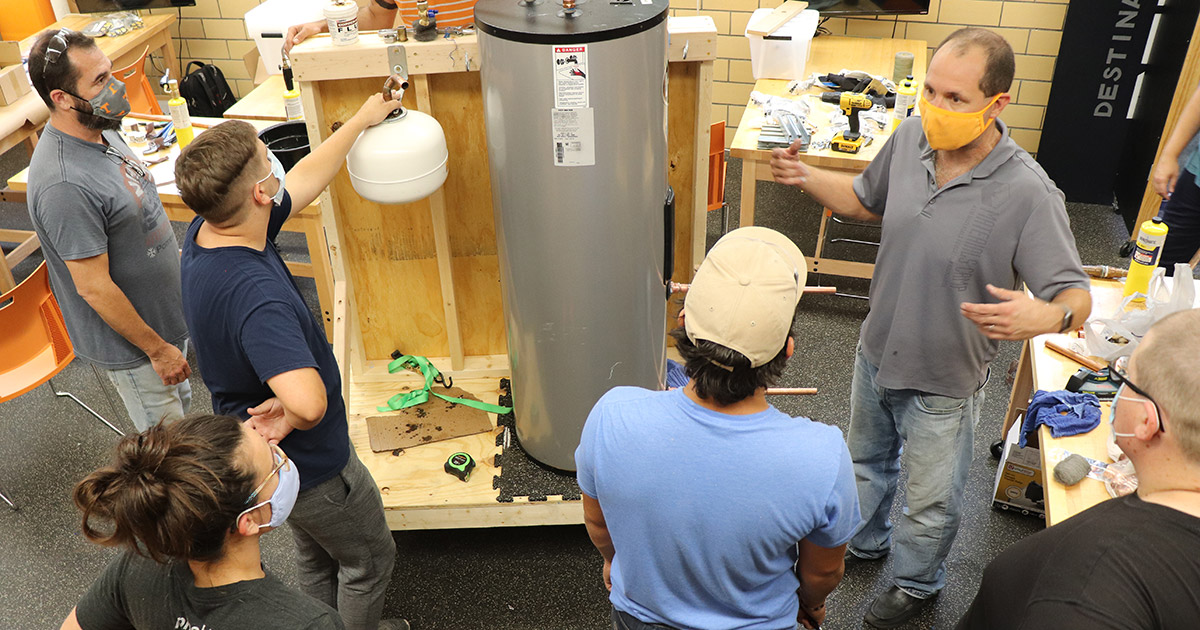 Chris Wetteland instructs the 2020 TranSCEnd cohort on the build of a solar-powered water heater.