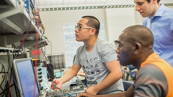 Two grad students work in a Power Lab