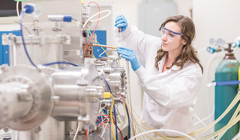 Female student works with equipment in a nuclear engineering lab
