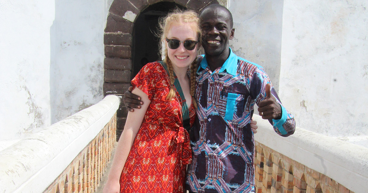 Savannah Davidson poses with a guide at Elmina Castle.