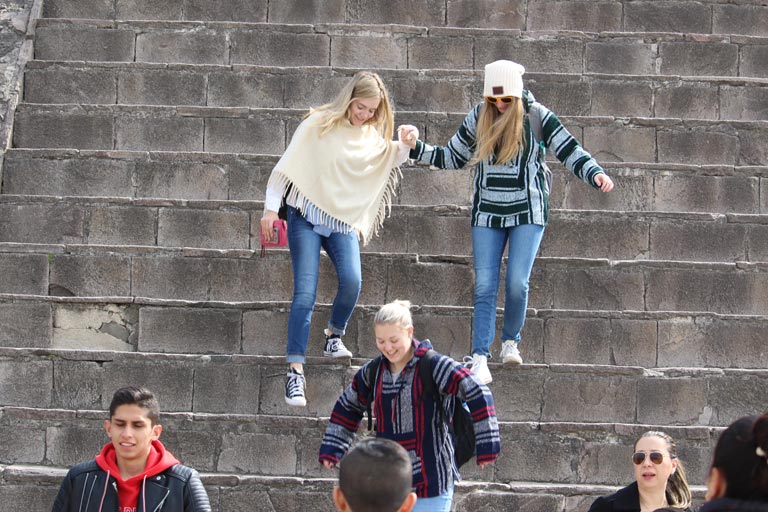 Kate Stiles, Gillian McGlothin, and Kelsey Hay descend the steps of the Pyramid of the Moon at Teotihuacan