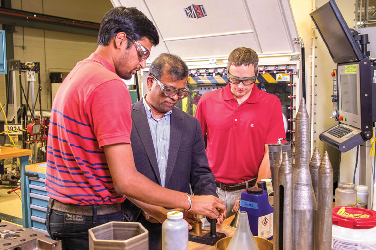 Suresh Babu works with students in his lab