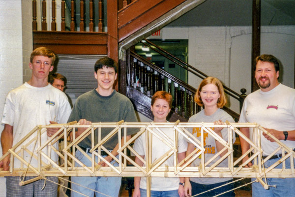 Students from the first engage class hold up their bridge project