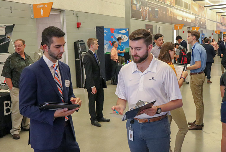 Student speaks to employer at the Engineering Expo