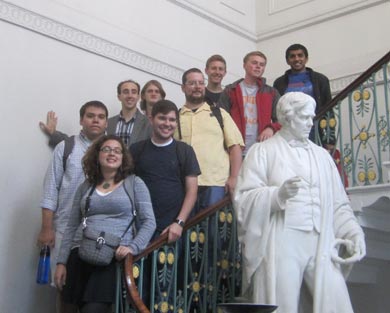 Students pose in front of statue
