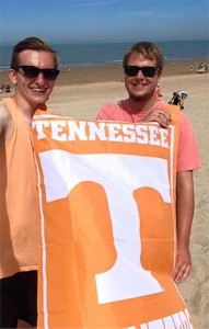 Parker Dulin and James Swart on the beach with a University of Tennessee banner