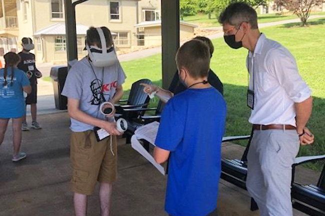 Multiple students use virtual reality headsets.