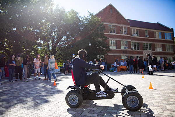 Students in the Engineering Courtyard using tricycles