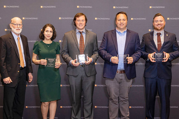 From left, Associate Dean Bill Dunne presents Anahita Khojandi, Brett Compton, James Coder, and Nicholas Brown with Professional Promise in Research Awards.