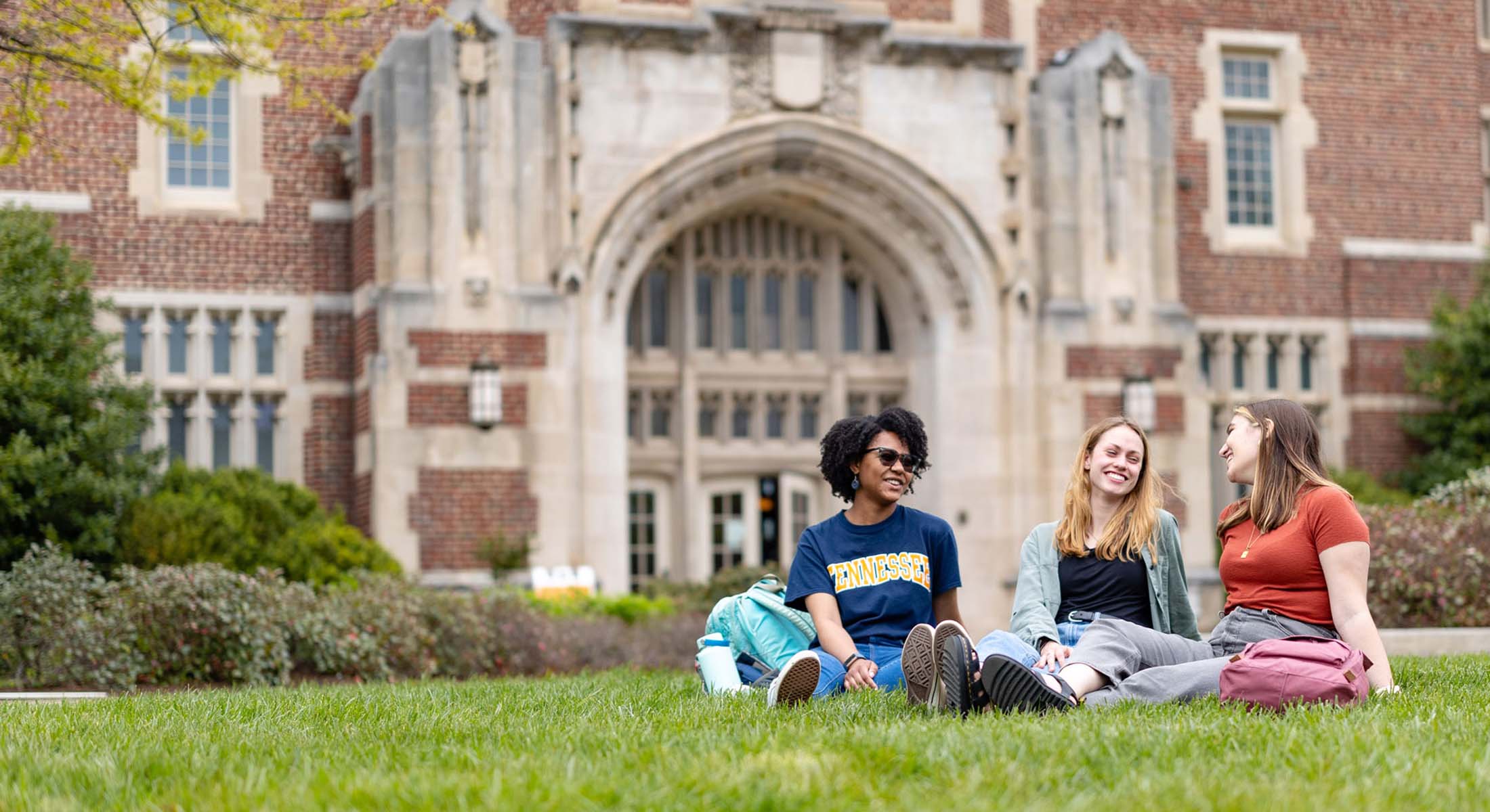Three women engineering students sit outside Ayres Hall