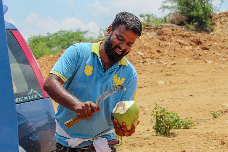 Indian Worker Cuts Open Coconut