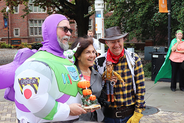 Dean Janis Terpenny presents "Buzz" and "Woody" with the 3D-printed 2019 Boo in the Courtyard trophy.