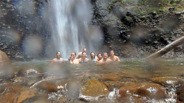 Global Initiatives Team Swims Underneath a Waterfall