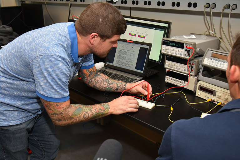 Weber works on a project inside an electrical engineering lab.